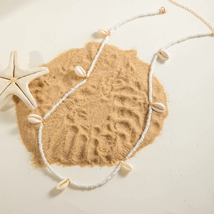 Detail of beaded shell waist chain with gold lobster clasp and starfish beach accessories