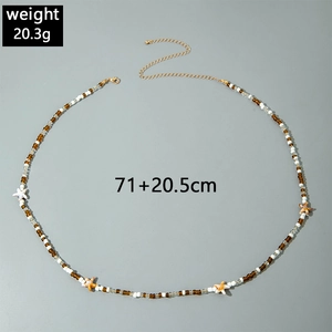 Close-up of beach bead waist chain with starfish charms and gold extender chain