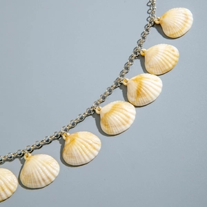Detail of silver link chain body jewelry with natural sea shell charms for beach outfits