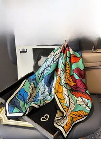 Detailed macro view of high-quality silk twill scarf with vibrant feather pattern print