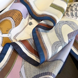 Detail of silk twill scarf showing equestrian patterns and high-quality rolled edges
