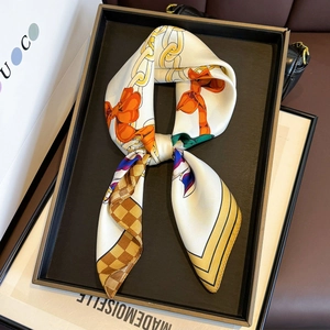 Elegant 65cm silk square scarf with golden chain and orange bow print on black tray
