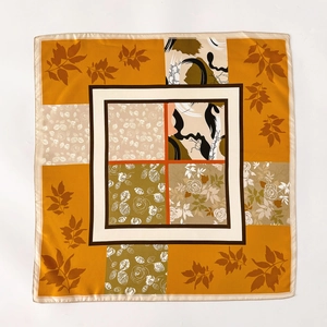 Silk twill square scarf with geometric patchwork and maple leaf pattern in warm orange
