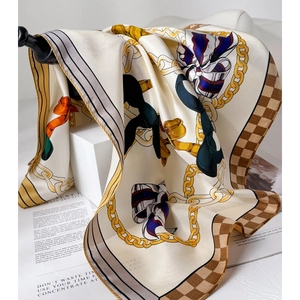 Elegant chain pattern silk scarf with golden and navy blue prints on geometric stands