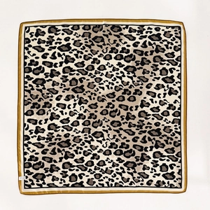 Classic leopard print silk square scarf with beige, brown, and black tones on white background
