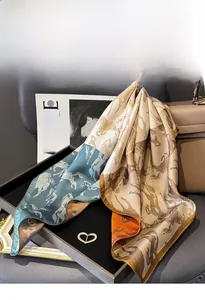 Detailed view of silk twill scarf with classic horse patterns and rolled edges