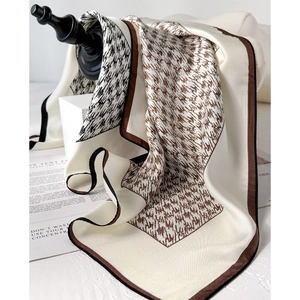 Elegant silk scarf featuring abstract brown houndstooth pattern on cream background