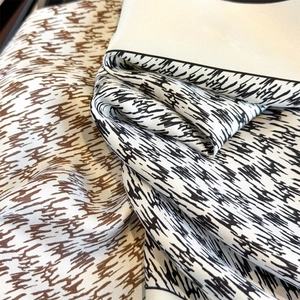 Detail of silk scarf showing vintage plaid patterns and artistic abstract brushstrokes
