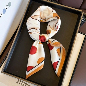 Silk twill square scarf with orange floral prints and black borders in elegant display