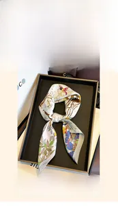 Detailed view of a 65x65cm pure mulberry silk scarf with vibrant floral and bird prints