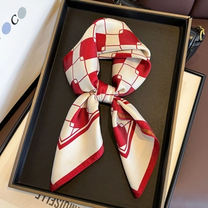 Luxurious red and white checkered silk scarf elegantly styled in a premium black tray