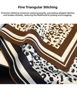 Detailed view of leopard silk scarf showing fine triangular needle stitching and texture