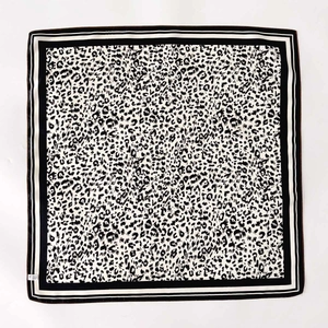 Classic black and white leopard print silk square scarf with striped border in flat lay view