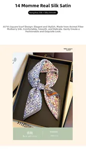 Détail d'un foulard en soie 14 Momme plié sur un plateau noir avec un magazine de mode