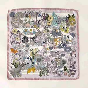 Silk scarf featuring intricate safari animal patterns with zebra and peacock prints