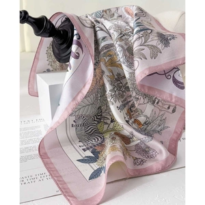 Elegant pink silk twill scarf with jungle wildlife and tropical botanical print on stand