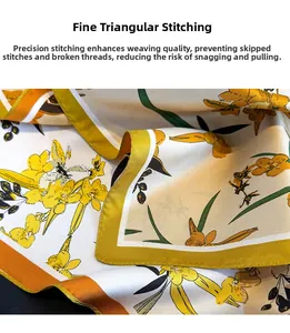 Detailed macro view showing the fine triangle stitch hem on yellow floral silk scarf