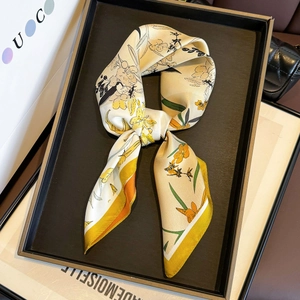 Floral silk twill scarf with yellow flowers and green leaves on a beige background