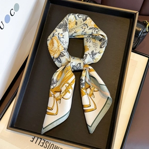 Elegant silk twill square scarf with yellow rose and equestrian prints on display