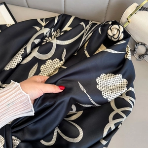 Silk-textured camellia print long scarf with elegant chain pattern on black background