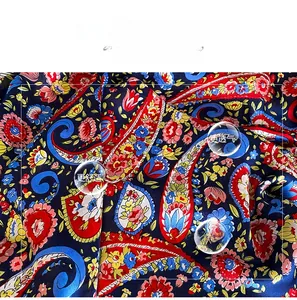 Macro detail of soft paisley pattern faux silk fabric with elegant blue texture