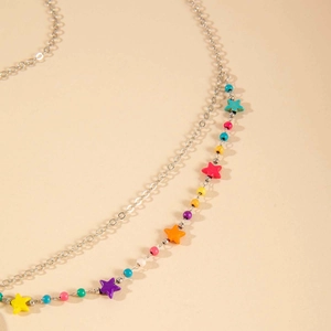 Détail d'une chaîne de tête argentée multicouche avec perles et étoiles de style bohème