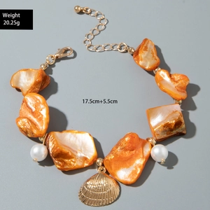 Detail of starfish bracelet with orange shell beads, white pearls and gold shell charm