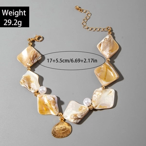 Marine style shell bracelet featuring pearl charms and a golden scallop pendant detail