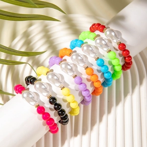 Rainbow beaded bracelet set featuring baroque pearls and gold spacers on white display