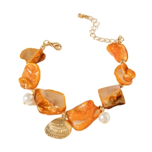 Ocean style gold bracelet with orange stones, white pearls and a seashell charm