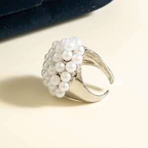 Macro shot of a vintage-style cluster pearl ring with an adjustable silver band