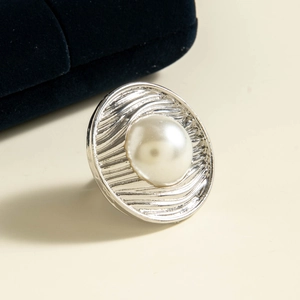 Detail of vintage silver pearl ring with irregular floral texture on jewelry box