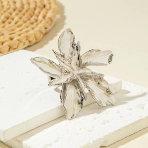 Detailed close-up of a silver irregular flower ring with artistic petal textures