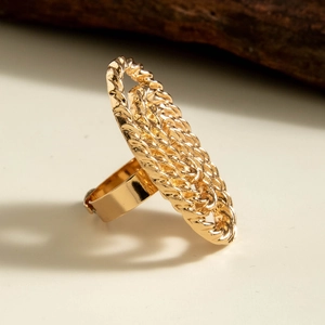 Macro view of a gold statement ring with an intricate woven chain texture and 3D design