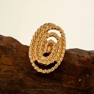 Close-up of golden vintage spiral ring with intricate twisted rope texture detail
