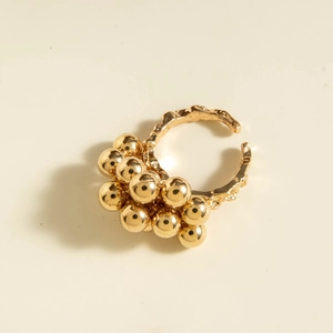 Macro detail of golden clustered beads and irregular textured ring band finish