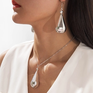 Elegant silver teardrop necklace and earrings set with high-polish metallic finish