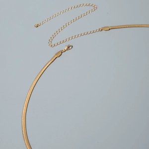 Dettaglio di una catena a serpente dorata con chiusura a moschettone e estensione