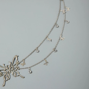Detail of silver butterfly waist chain featuring double layers and sparkling zircon accents