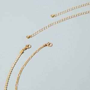Detail of golden butterfly waist chain showing lobster clasp and sparkling rhinestone link