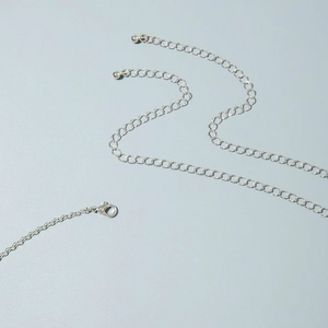 Detailed view of silver butterfly waist chain with lobster clasp and extension beads