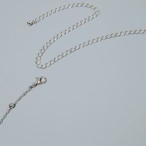 Detailed shot of silver butterfly body chain with lobster clasp and extension link