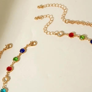Detail of adjustable gold-tone chain with colorful rhinestones and secure lobster clasp