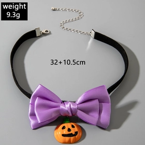Detail of Halloween choker with black braid, purple bow, and resin pumpkin charm
