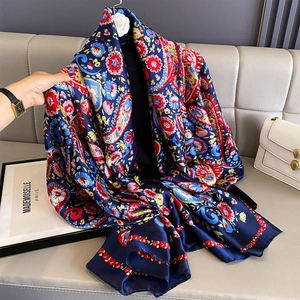 Detail of premium silk shawl showing intricate paisley patterns and satin texture