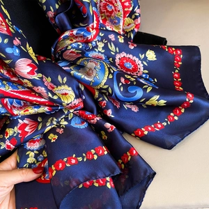 Close-up of lightweight silk shawl featuring vibrant blue cashew floral paisley patterns