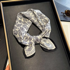 Silk neck scarf with paisley pattern on white background with black border