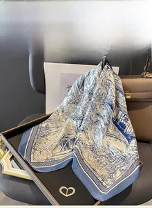 Detailed texture of a premium mulberry silk scarf with blue Chinese landscape patterns