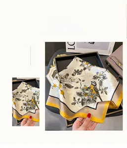 Close-up of floral and yellow bird print on elegant ivory silk square scarf detail