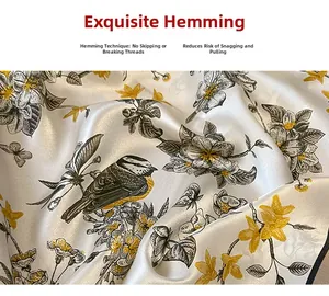 Close-up of premium silk scarf featuring delicate hand-rolled edges and floral bird patterns